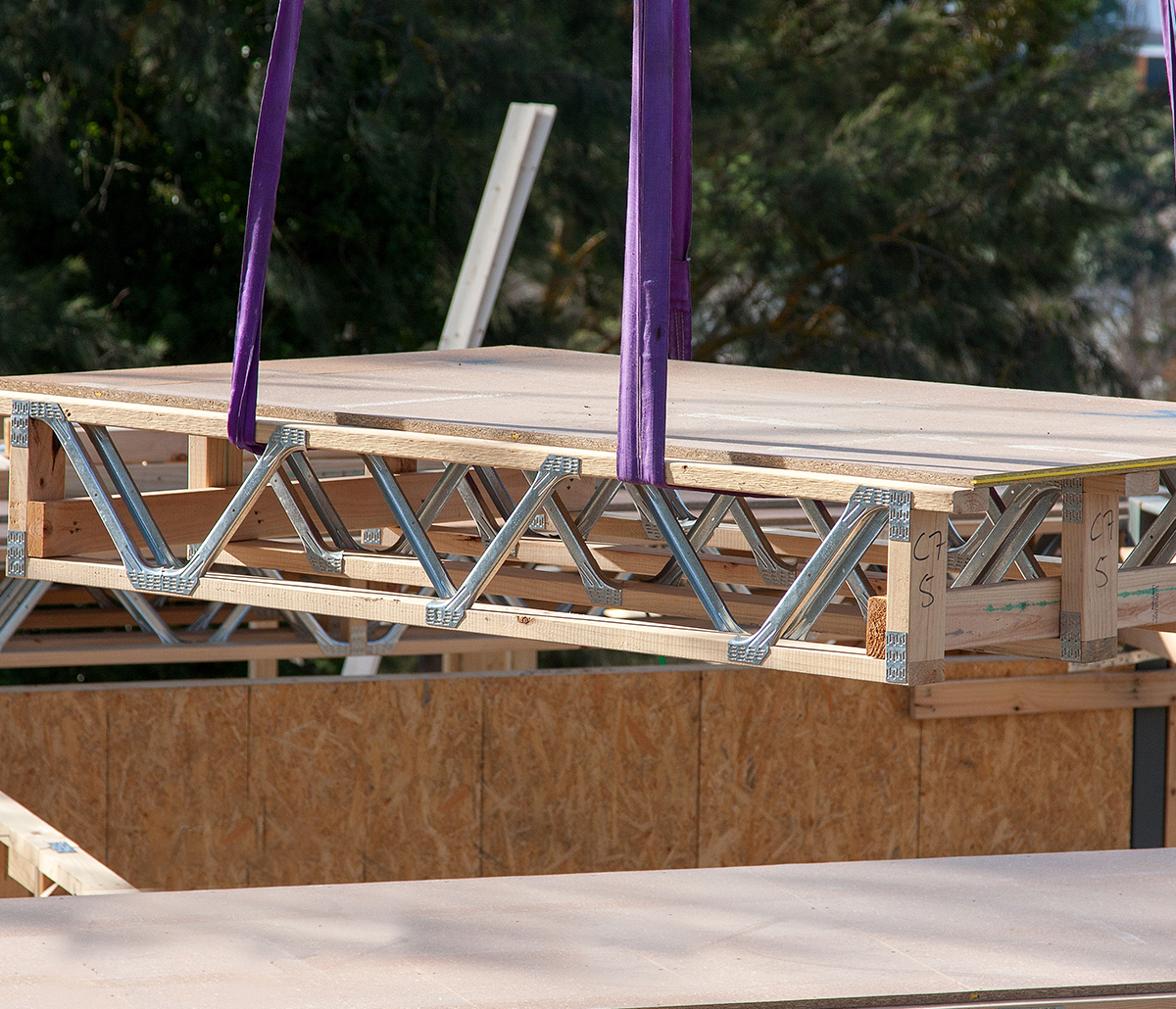 MiTek Floor Cassettes Engineered Systems Products - Wooden floor cassettes being hoisted into construction site